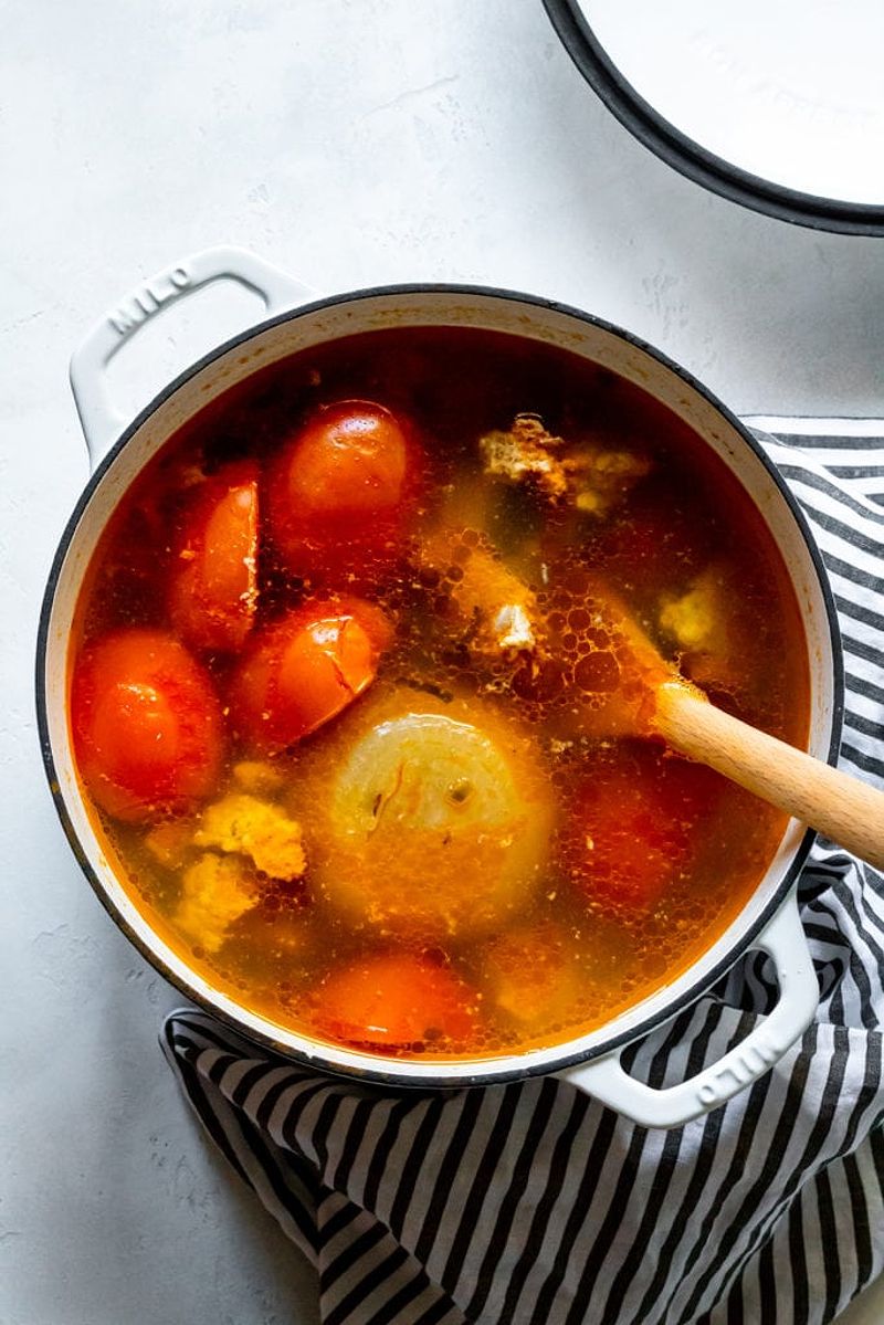 A bowl of vibrant Bun Rieu soup showcasing its rich colors and ingredients