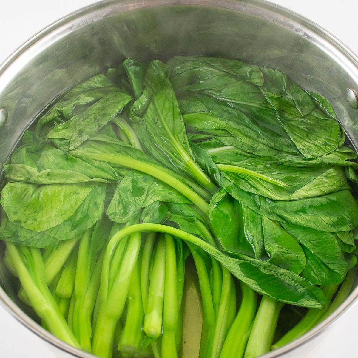 Blanching choy sum in a pot