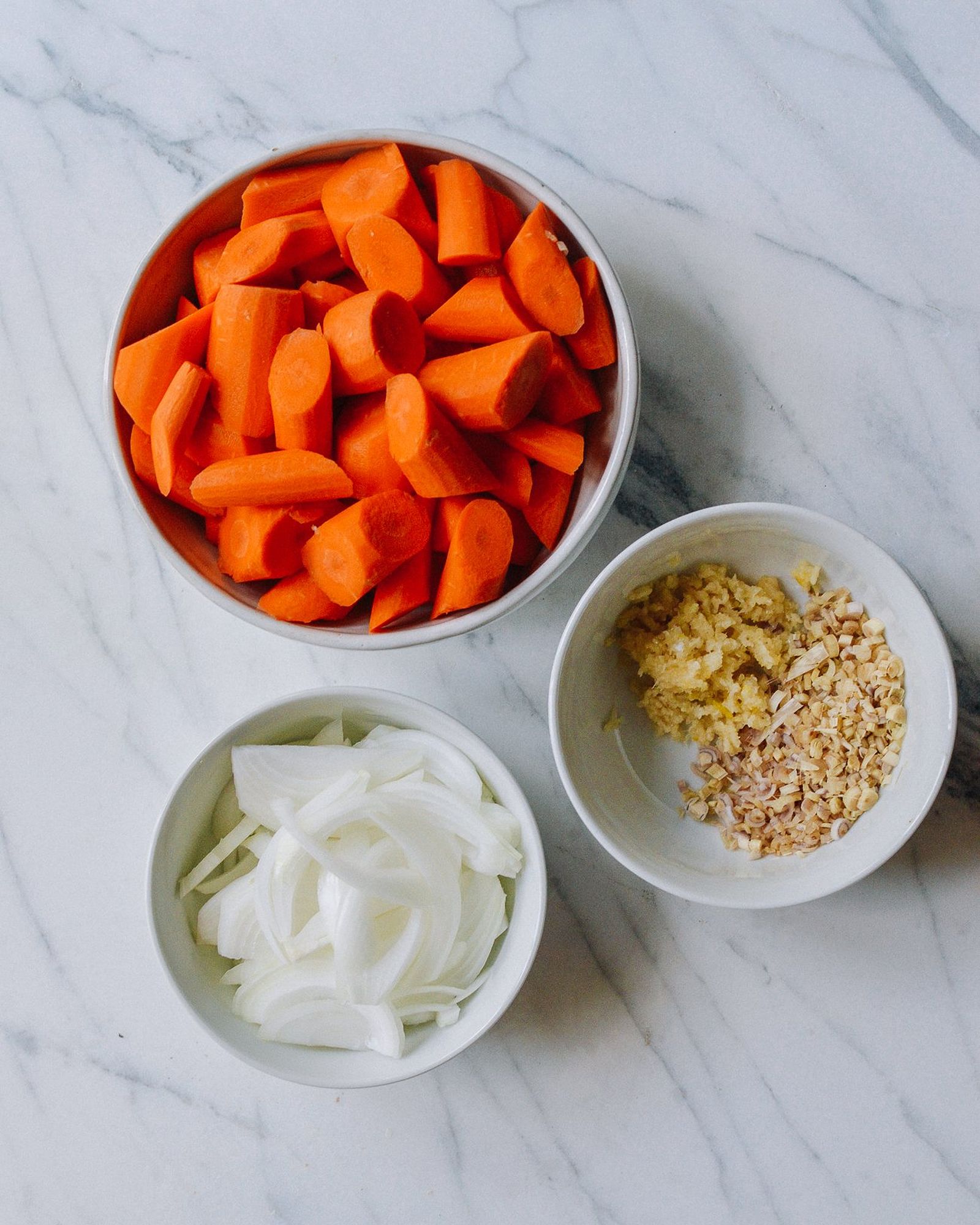 Bowl of carrot chunks, onion, ginger, and lemongrass