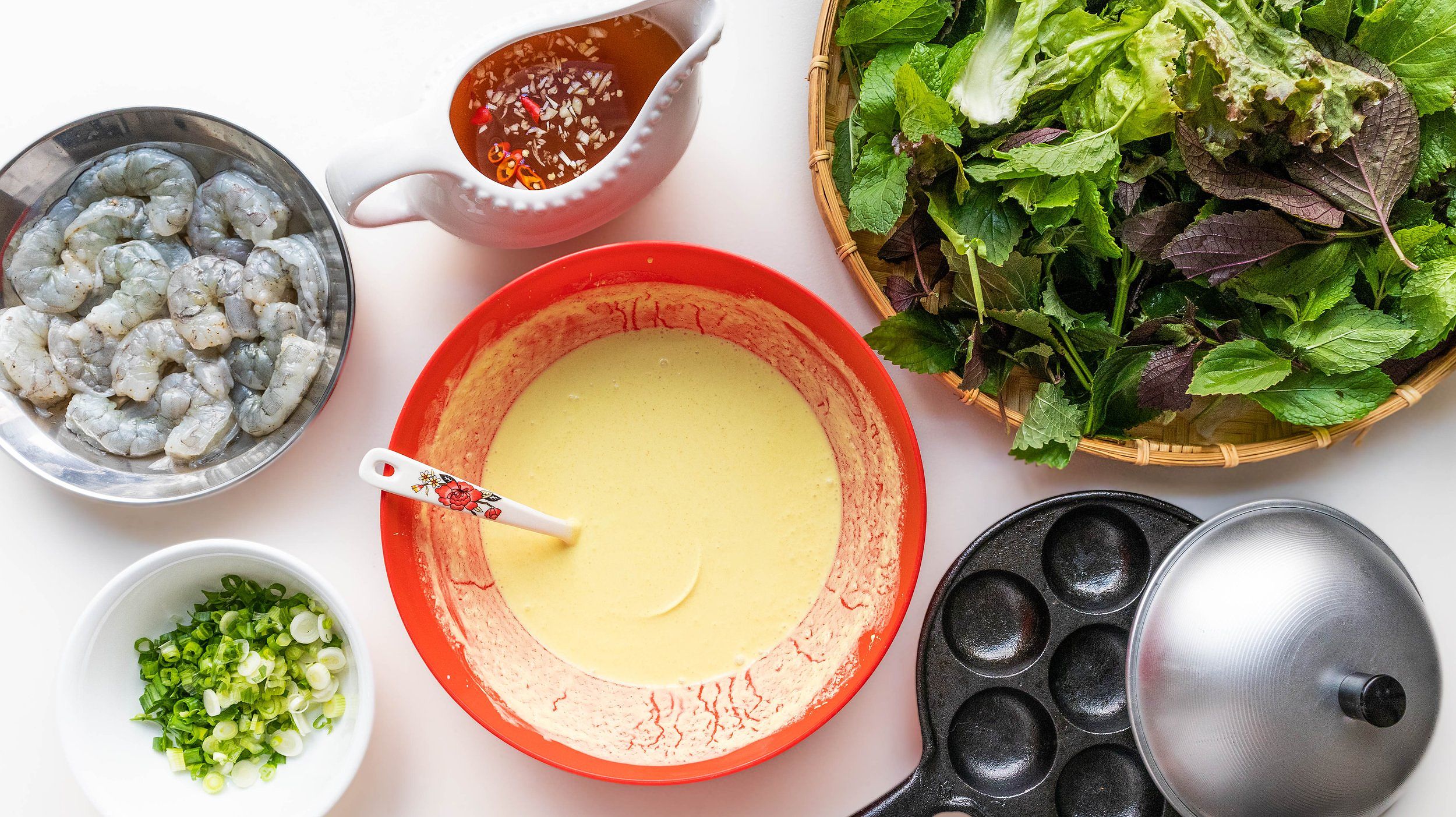 Cooking banh khot in a specialized pan