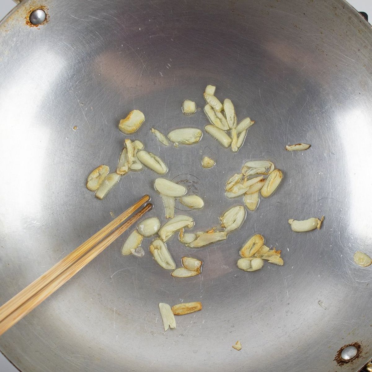 Sauteing garlic with oil for a choy sum stir fry