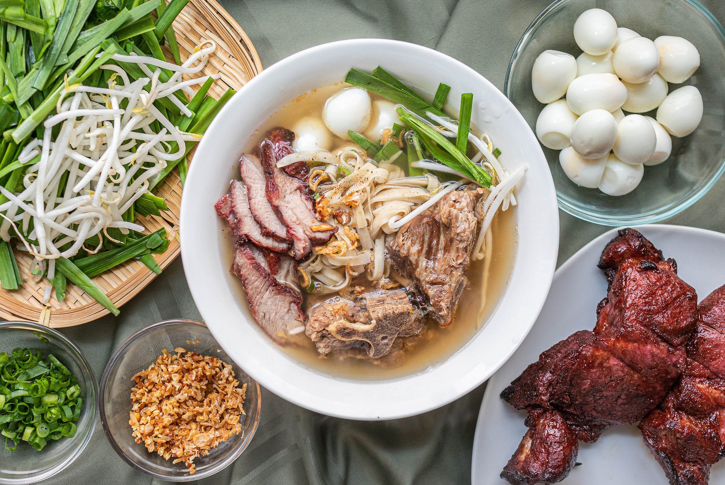 A colorful bowl of Vietnamese seafood noodle soup with shrimp and squid