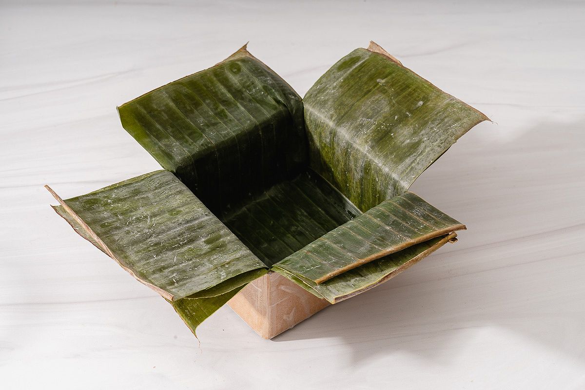 Banana leaves lined in a mold for wrapping banh chung