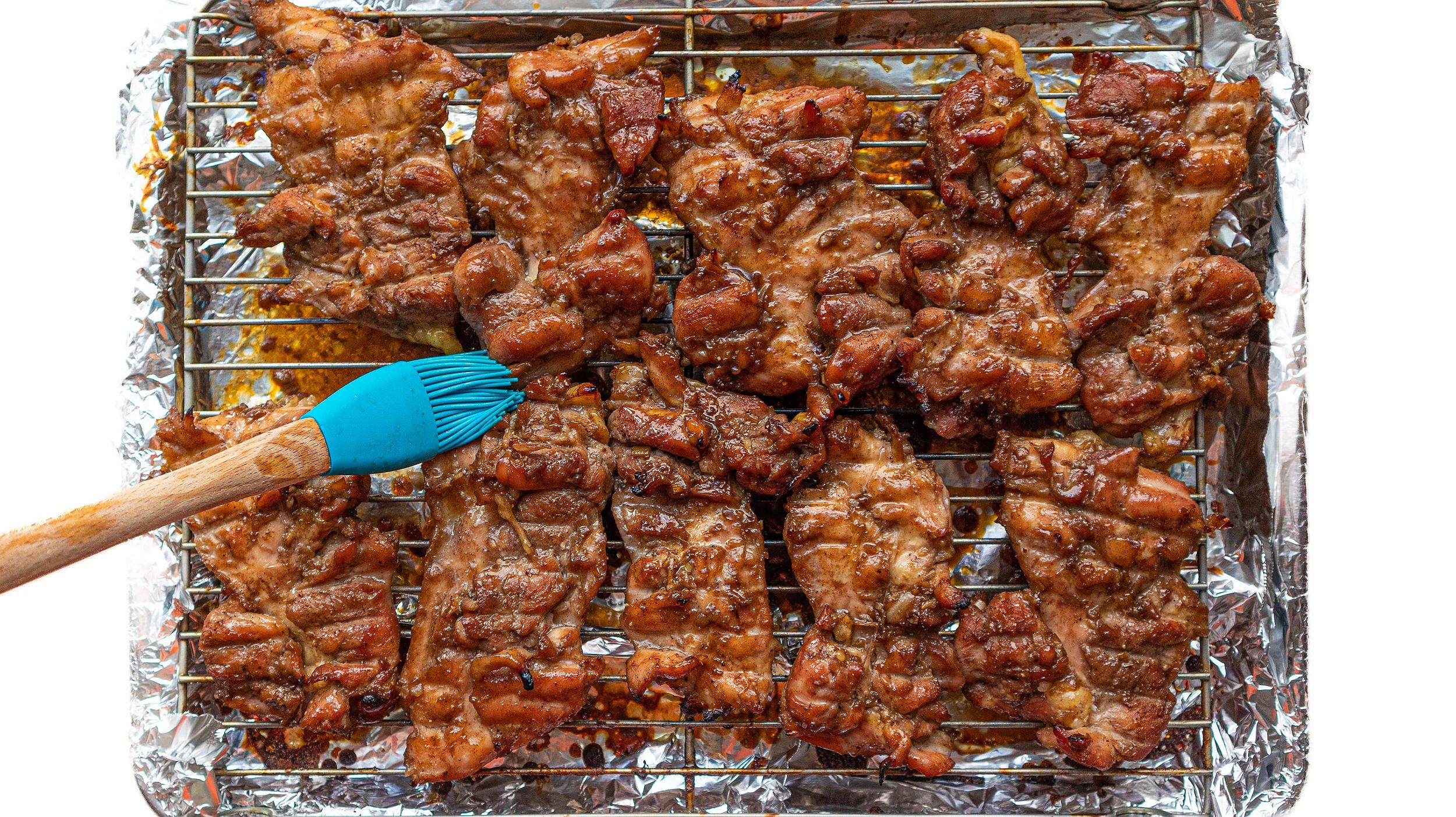 Basting chicken for Vietnamese lemongrass roast chicken (gà nướng)