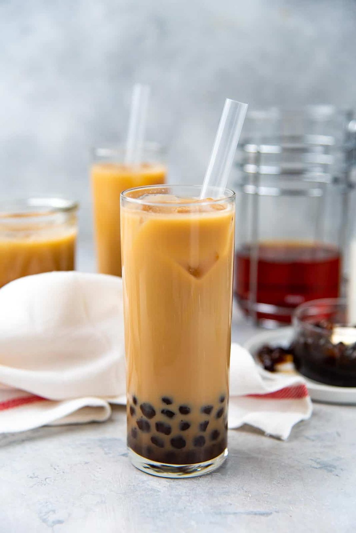 Bubble tea served in a glass with a fat straw