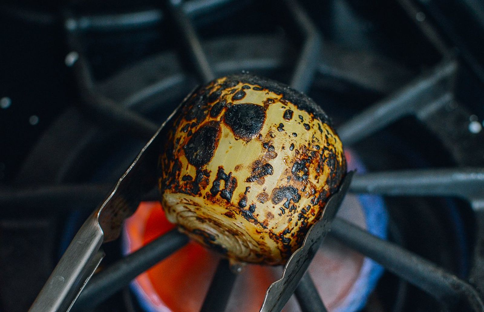 Charring onions over the stove