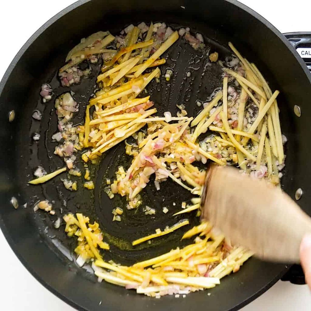 Frying the aromatics with the ginger