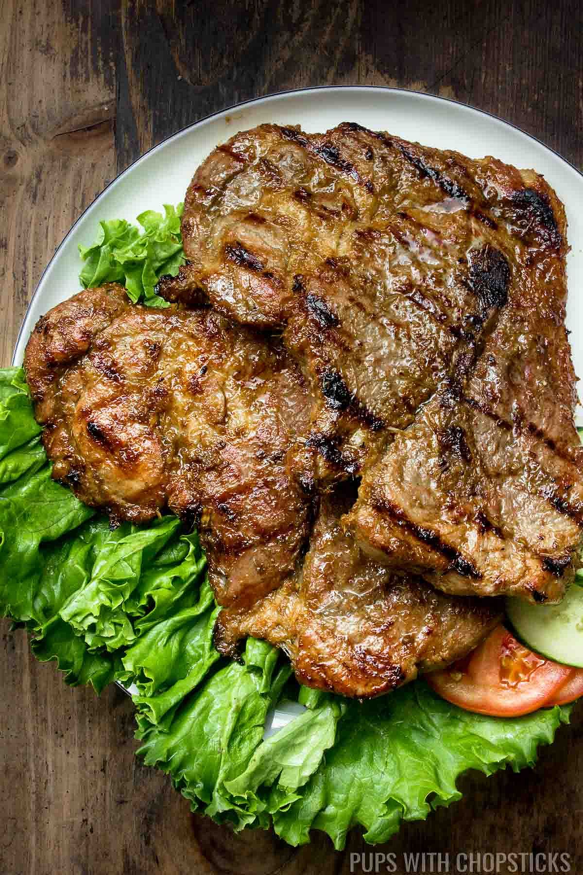 Grilled lemongrass pork chops served with fresh vegetables