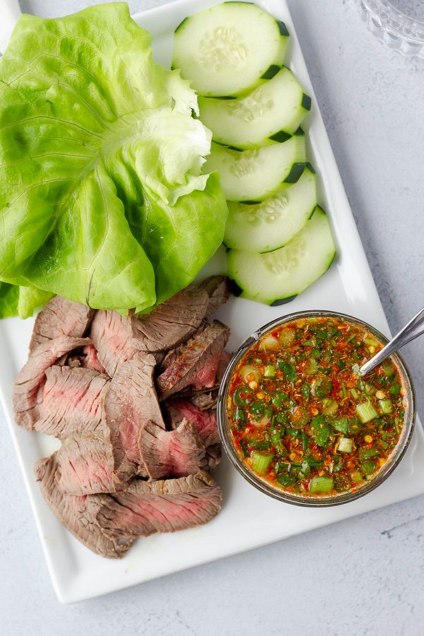 Overhead view of sliced grilled steak with accompaniments