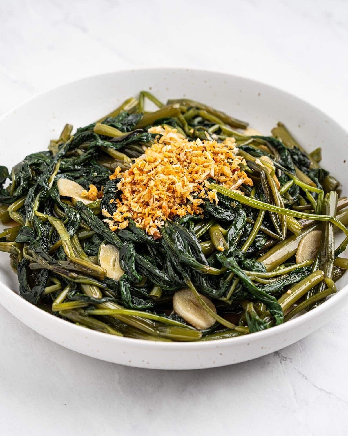 Plate of water spinach stir fried with garlic slices