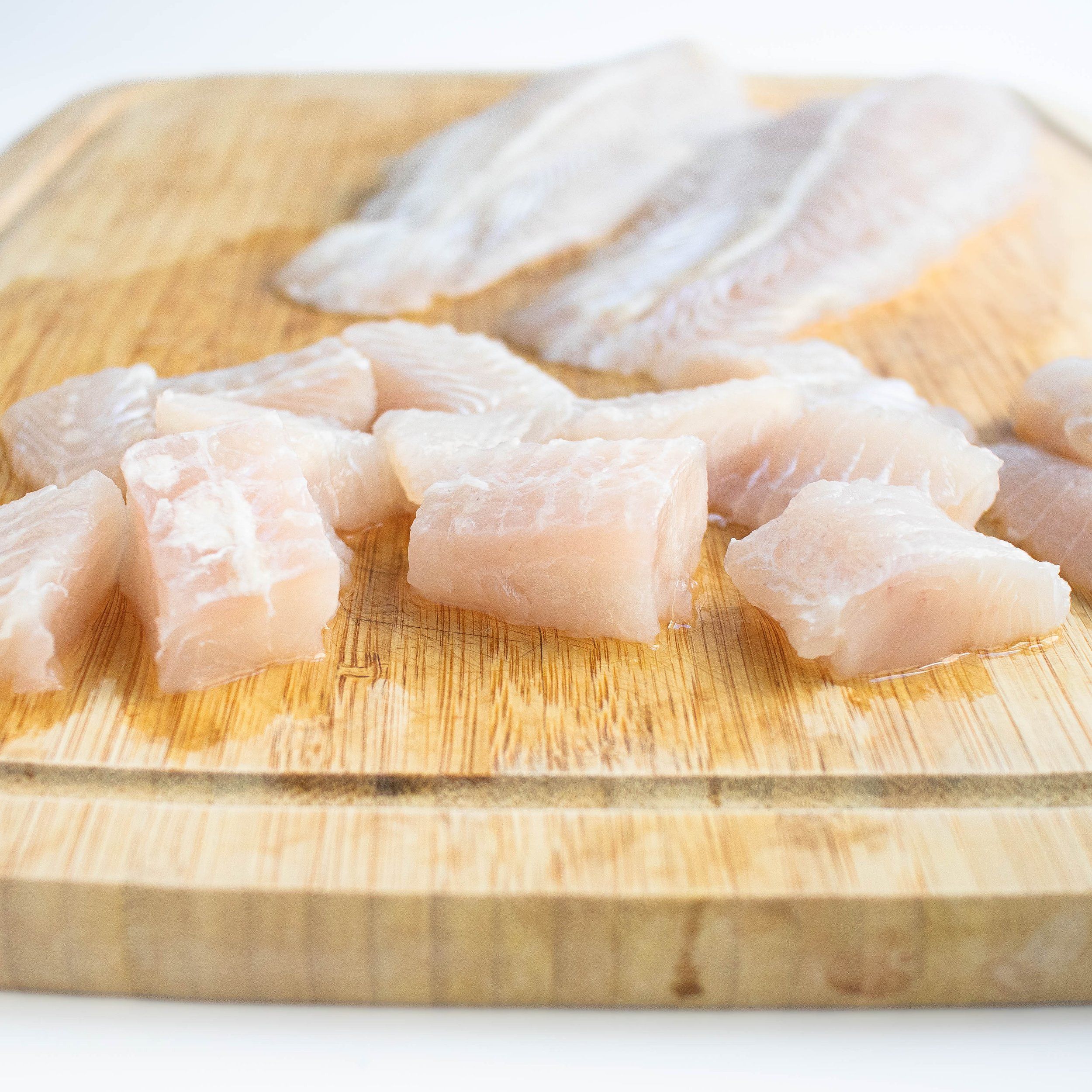 Swai fish fillets on cutting board