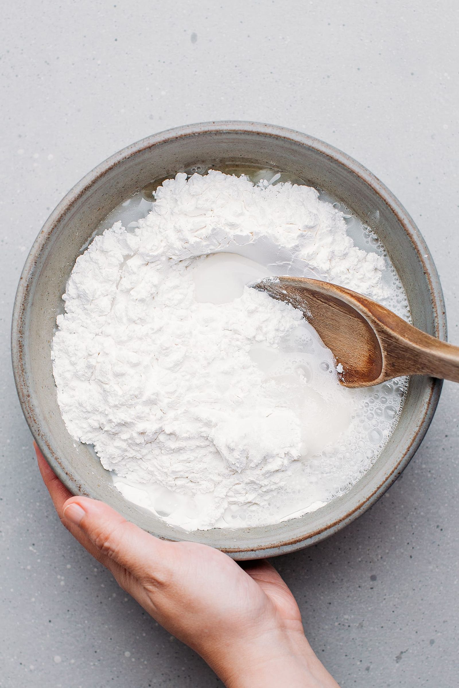 Whisking rice flour with sugar and water in a bowl